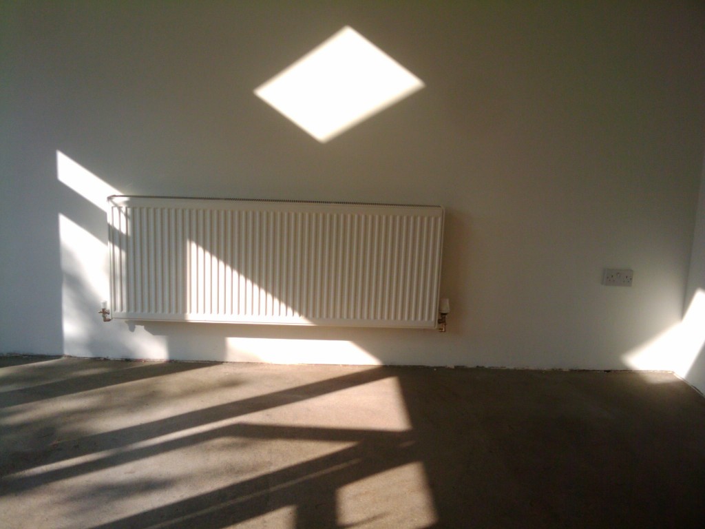 A sunny room and a very large radiator