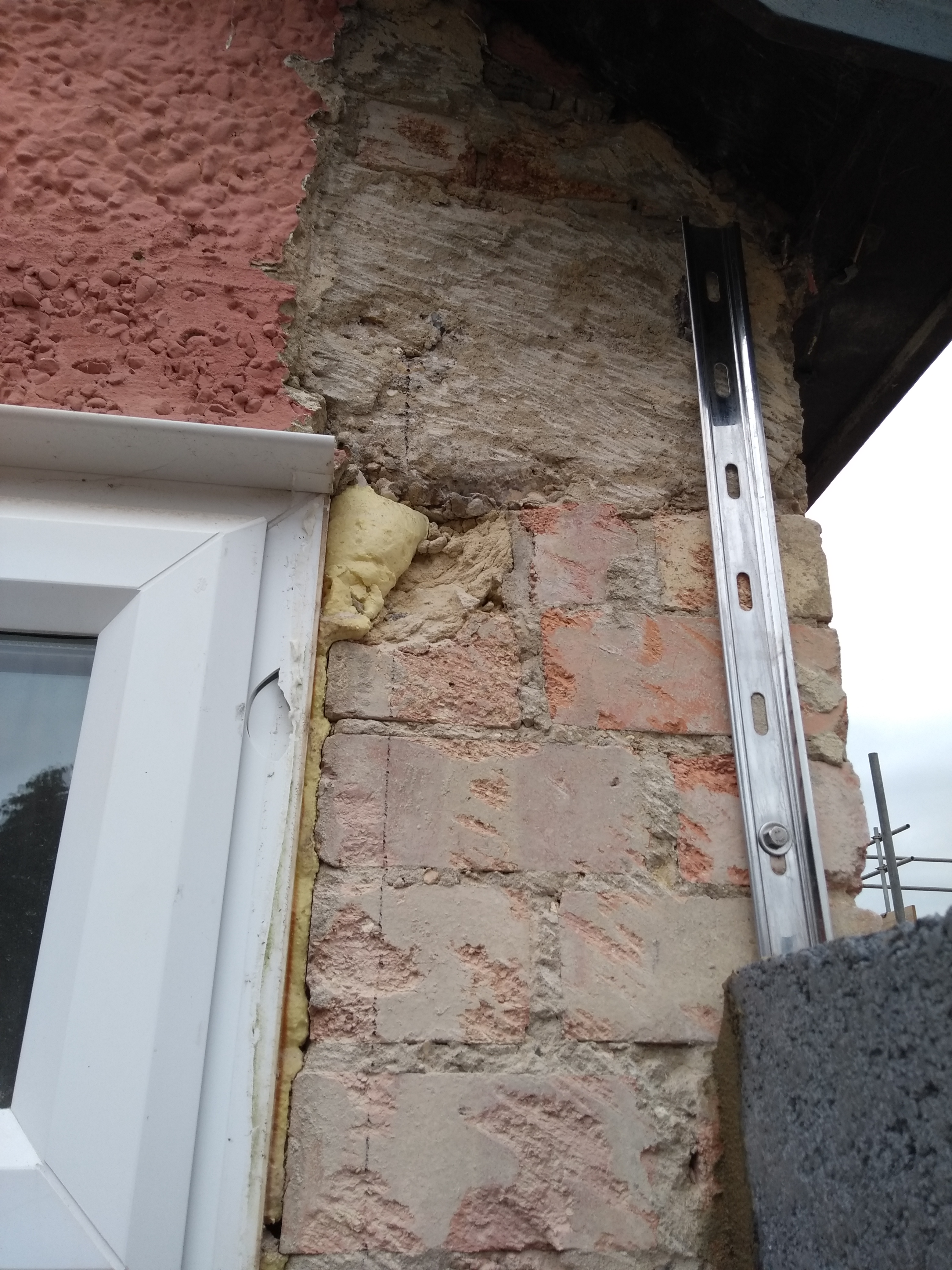 Brick wall starter with old wall exposed